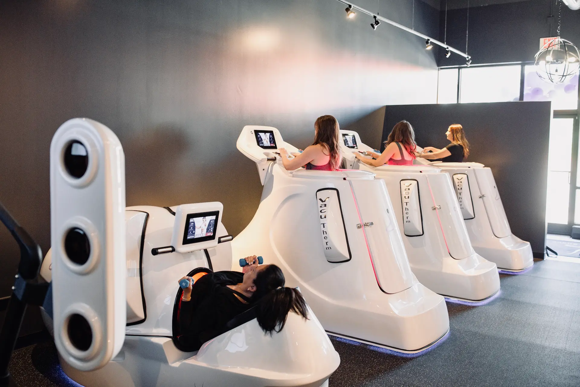 Women doing an infrared workout on VacuTherm machines at Lux Body Space in Downtown Wheaton