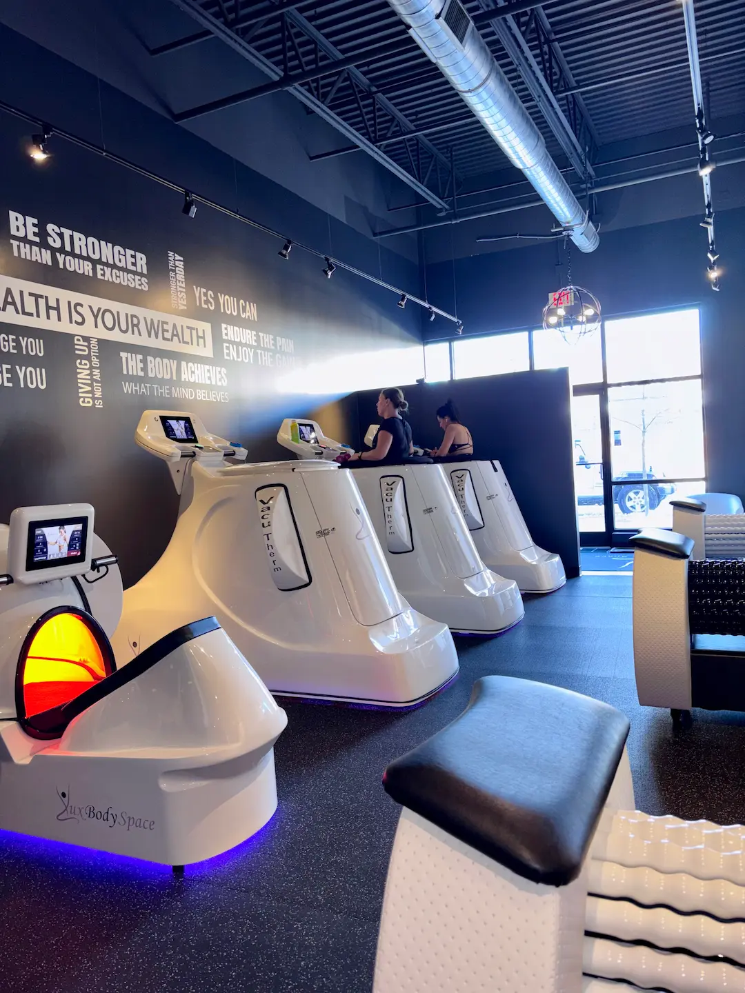 Women working out on the VacuTherm machines at Lux Body Space